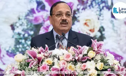 CJI Surya Kant speaking at a mediation symposium in Vijayawada alongside Andhra Pradesh Chief Minister N. Chandrababu Naidu.